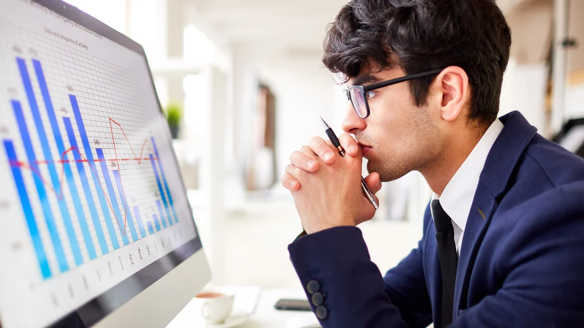Man Looking at Business Charts in a Display in context of predictive analytics